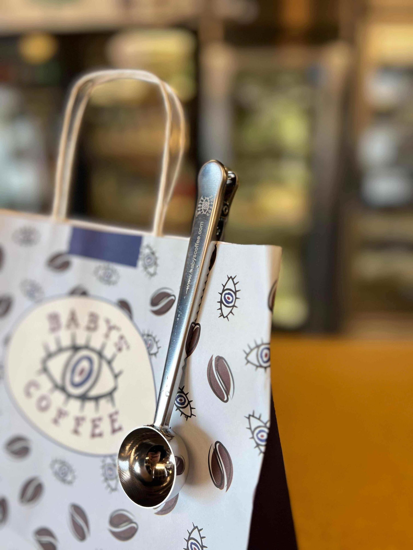 Engraved metal coffee scoop and bag clip with Baby’s Coffee logo