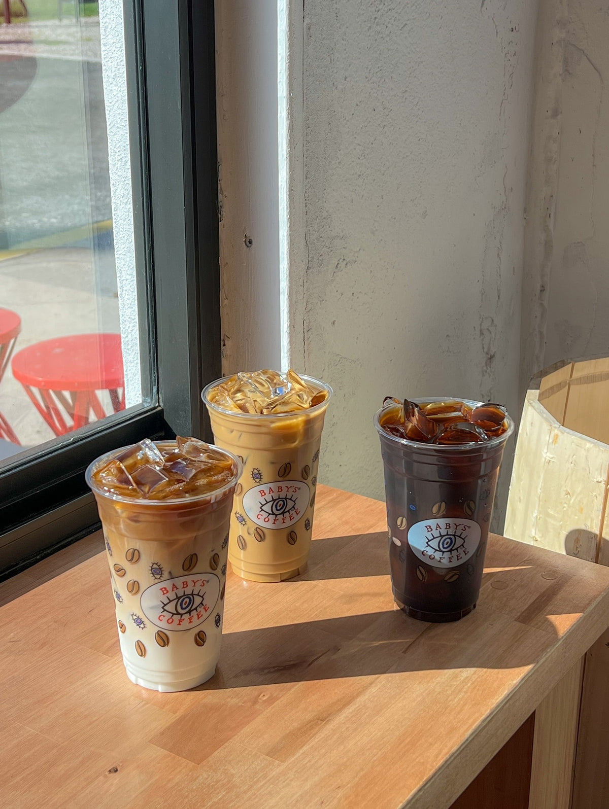 Three iced coffees on the window counter at Baby’s Coffee