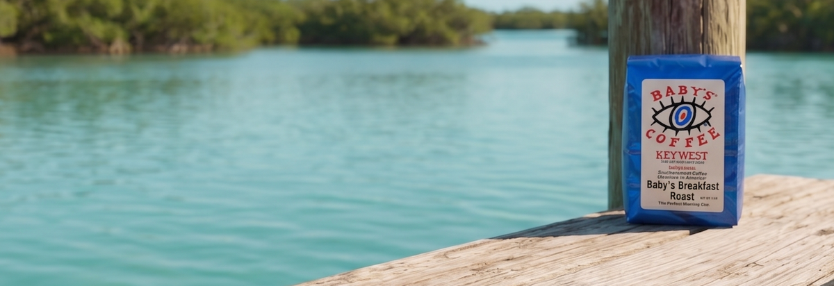 A blue bag of Baby’s Breakfast Roast beside turquoise water